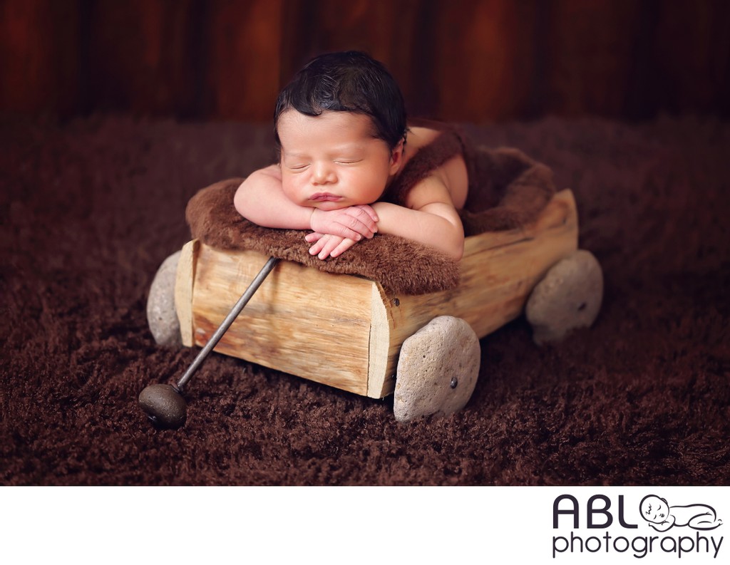 baby boy in wooden wagon, newborn photographer near me