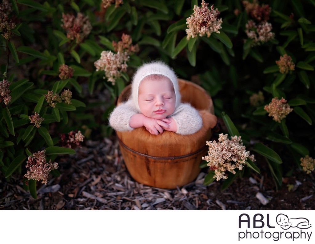 Outdoor newborn baby picture with flowers
