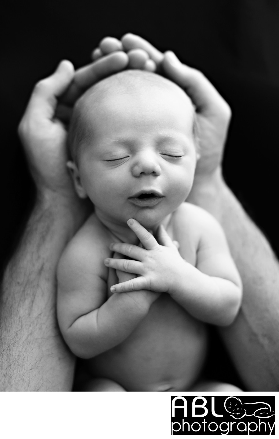 San Diego newborn photographer hands holding newborn