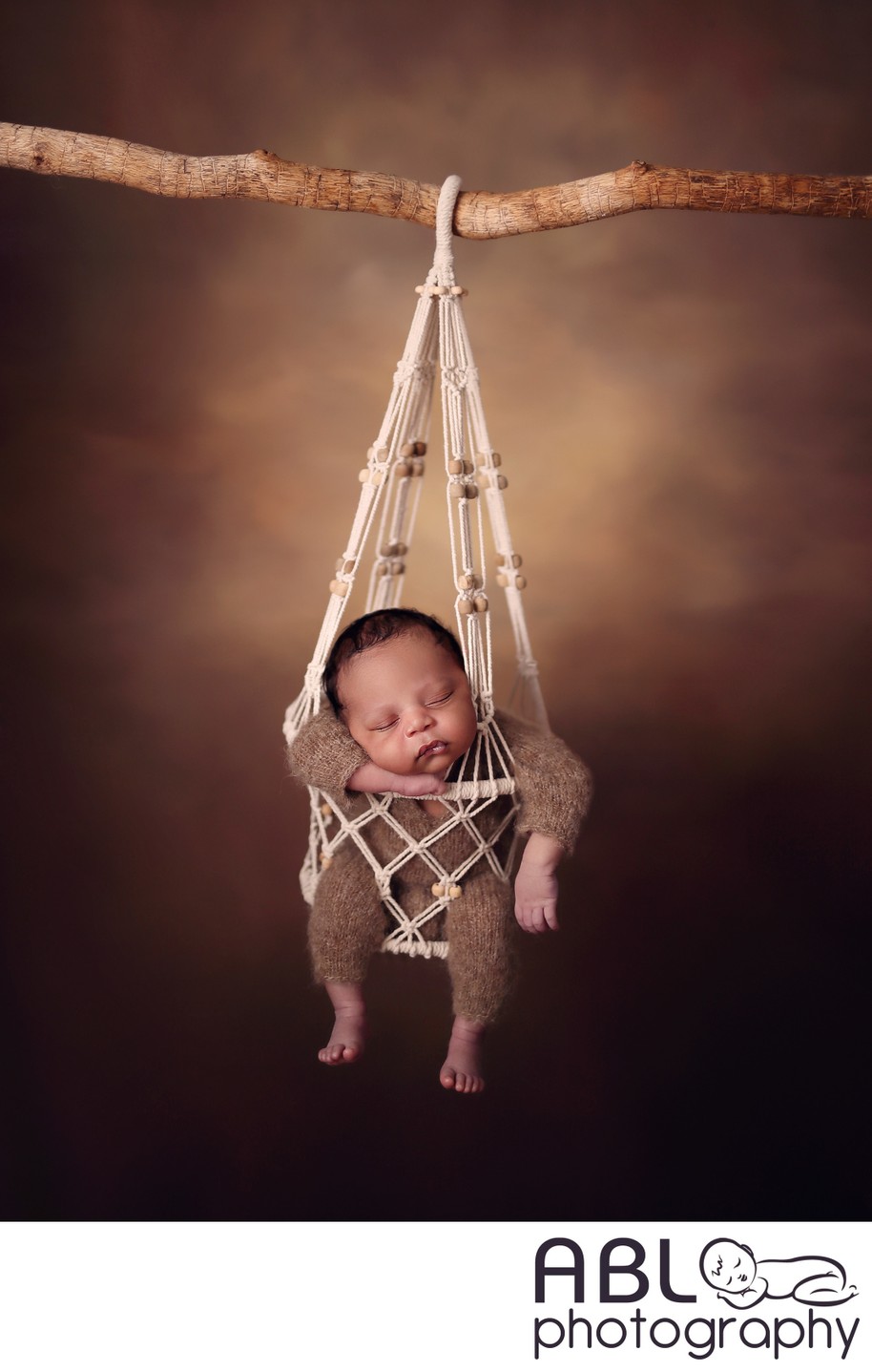 Carlsbad newborn photos, baby hanging from tree branch