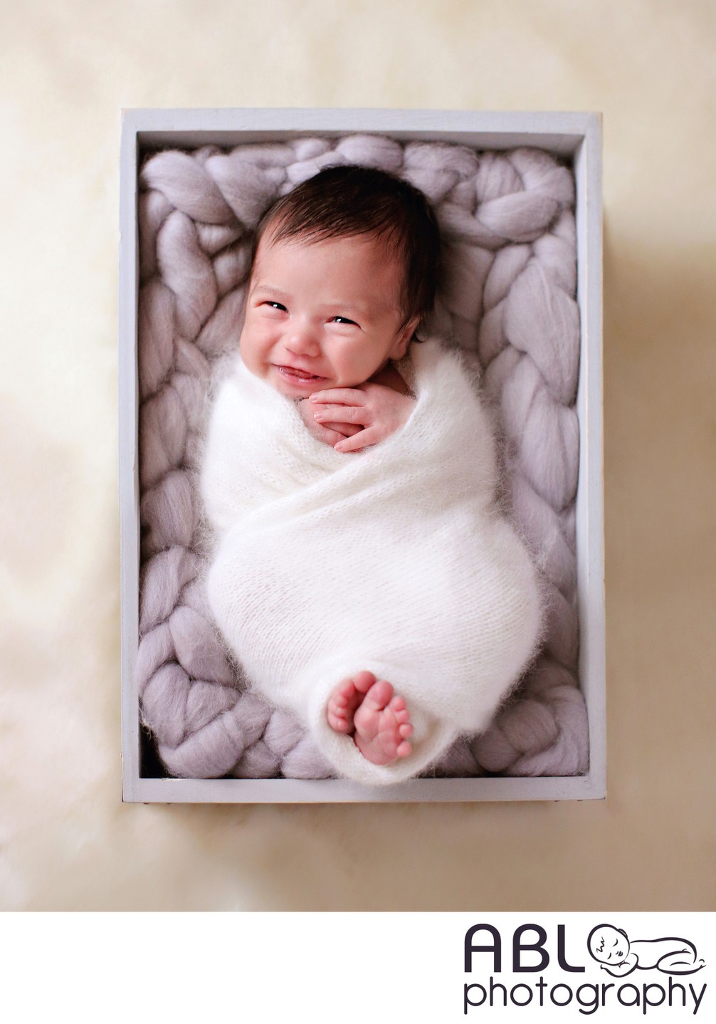 baby wrapped in gray box