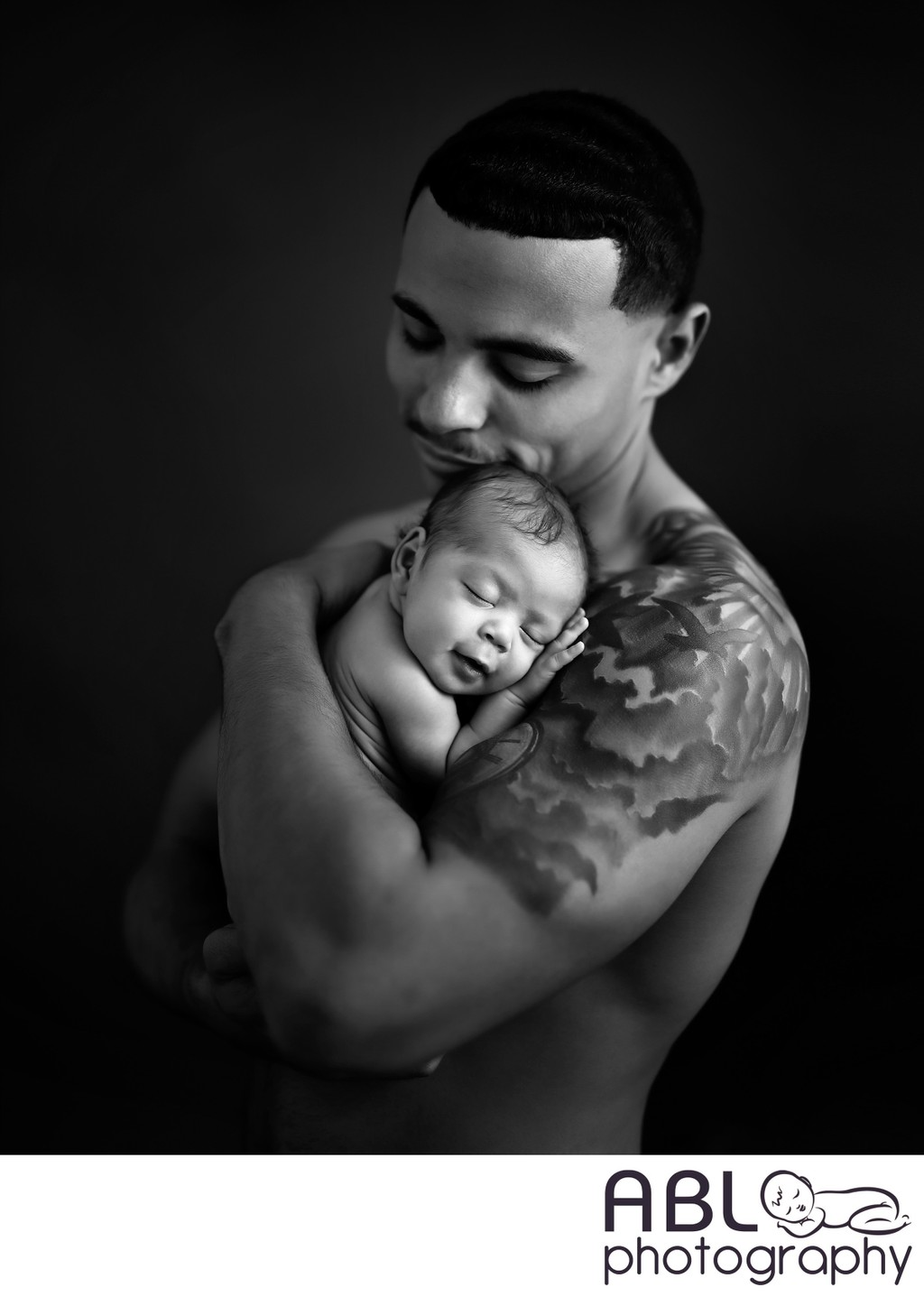 happy father with tattoo holding baby