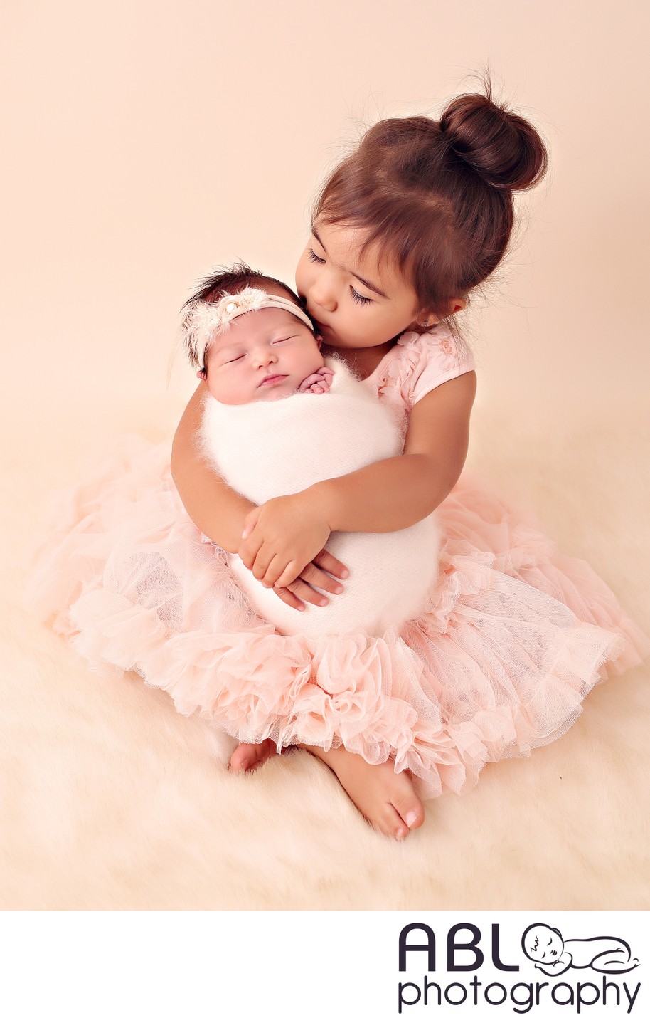 Girl holding newborn sister
