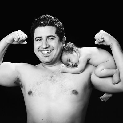 San Diego family photographer dad with newborn on shoulder