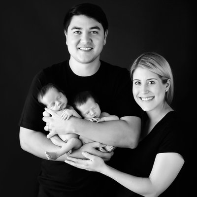 San Diego family photographer with family holding twins