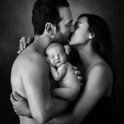 San Diego family photographer with parents holding newborn
