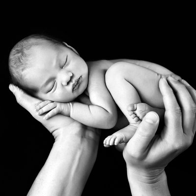 San Diego newborn photographer with holding newborn