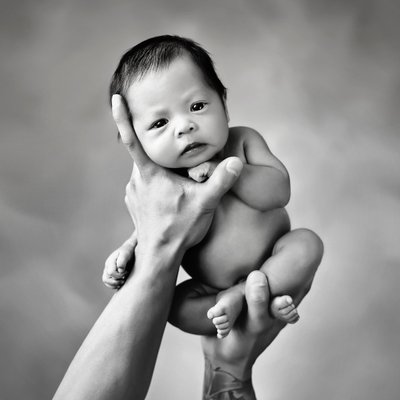 San Diego newborn photography. Newborn held up