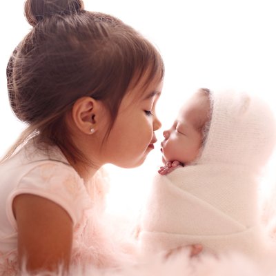 Newborn photography San Diego, sibling nose to nose pose