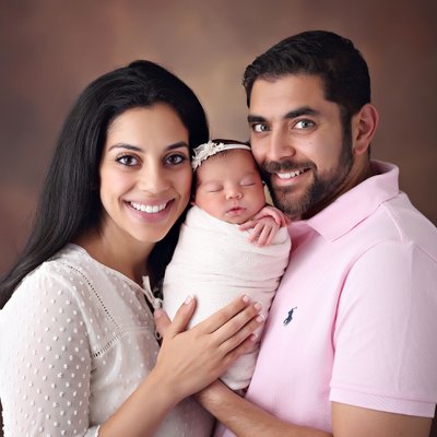 Parents smiling with newborn