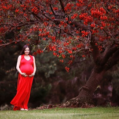 Pregnant girl in red maternity Dress