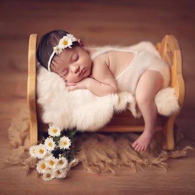 Baby on cradle in newborn photo studio Poway, CA