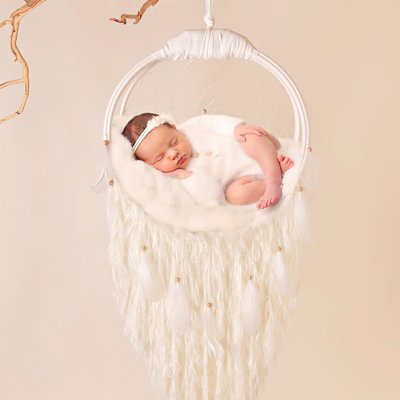 San Diego newborn photographers, baby hanging in cream