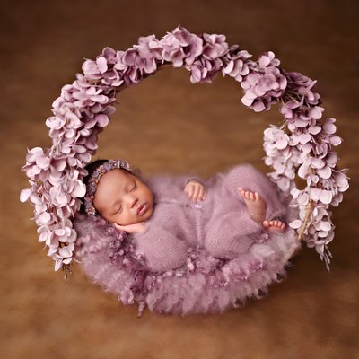 Baby in purple flower wreath