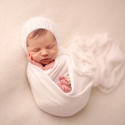 Posed baby photos on cream blanket