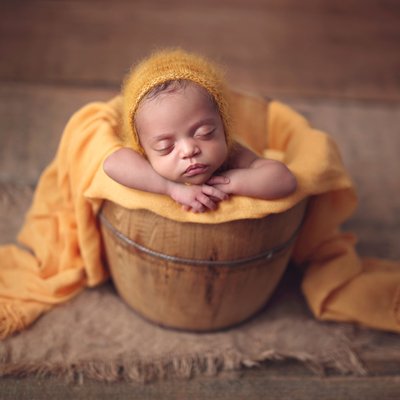 Baby with yellow scarf and hat