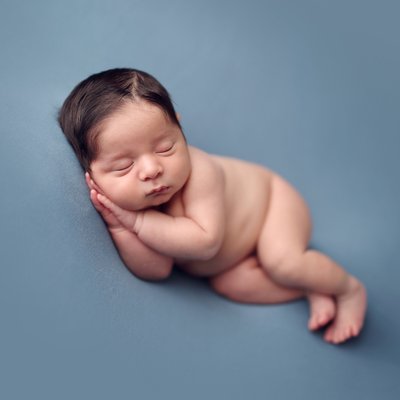 Newborn photos of baby boy on blue background
