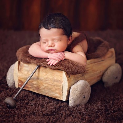 baby boy in wooden wagon, newborn photographer near me