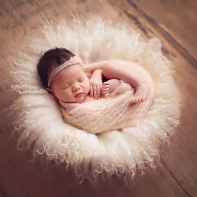 wrapped baby in wooden bowl