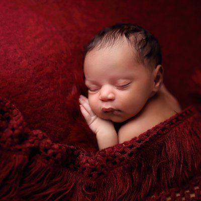 Baby on red blanket