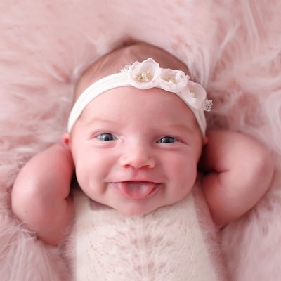 newborn girl making silly faces, San Diego photo shoot