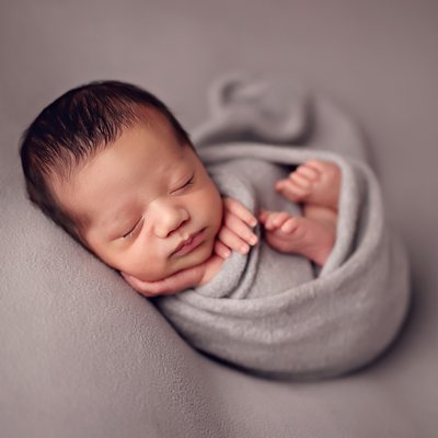 wrapped baby boy in gray