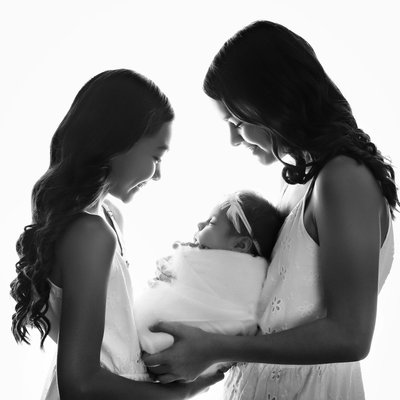 San Diego family photographer silhouette of sisters holding sister
