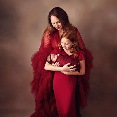 Mother and two daughters in red