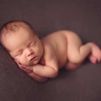 Baby boy on brown background
