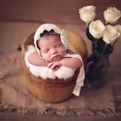 Newborn baby girl with flowers