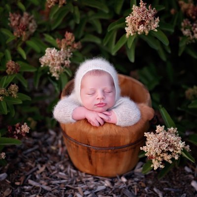 Outdoor newborn baby picture with flowers