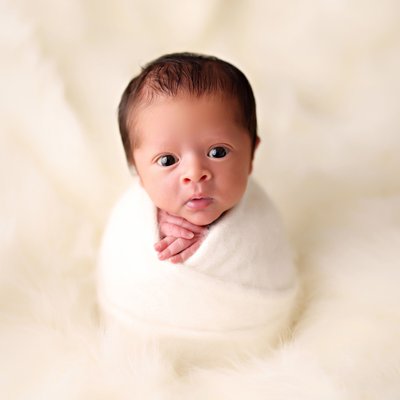 San Diego newborn session with wide-awake wrapped baby