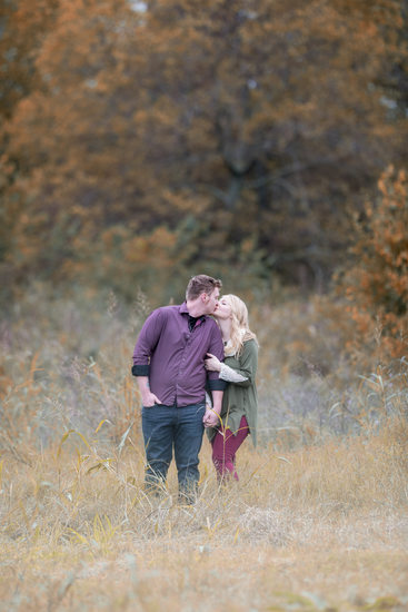 engaged couple in a field