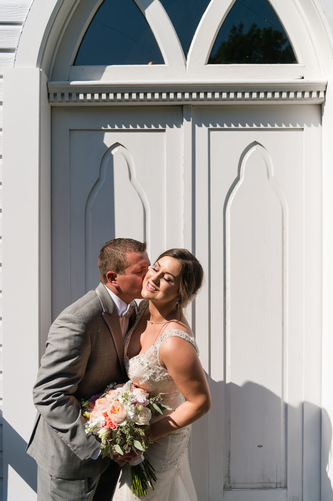 Kiss at First Lutheran Church Wedding Middelton