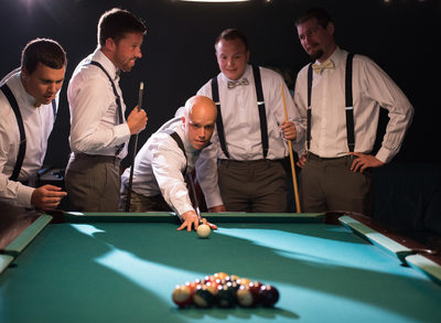 The groomsmen shooting pool