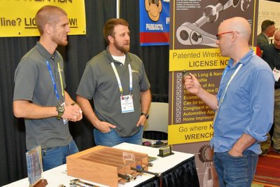 trade show photographer shows networking at the booth