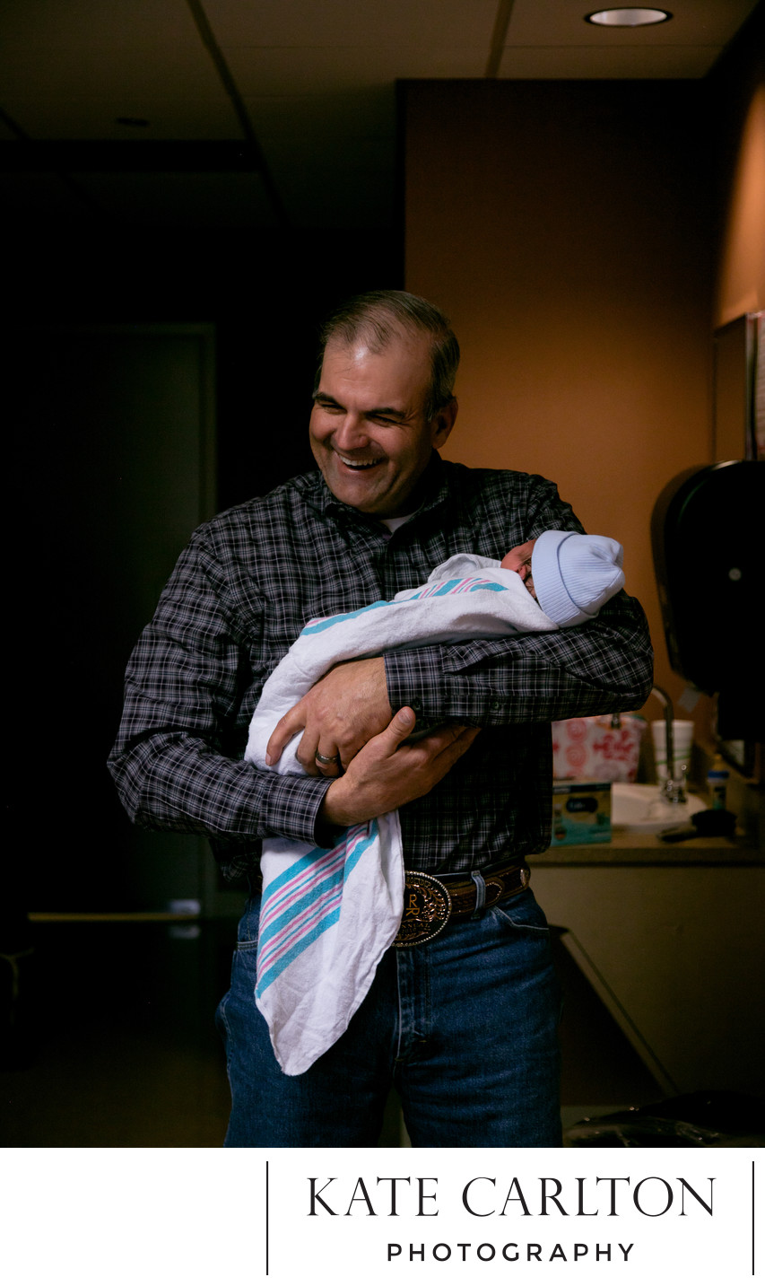 Father Holds Newborn at Home 