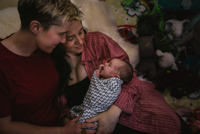 Intimate Moment Between Parents and Newborn Baby 