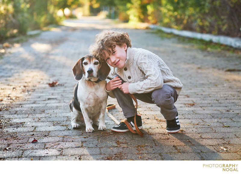 boy with beagle dog on a path in sam smith park