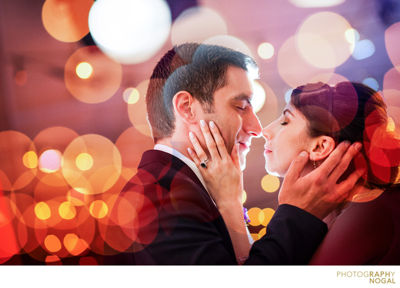 Bride and Groom About To Kiss in the Lights