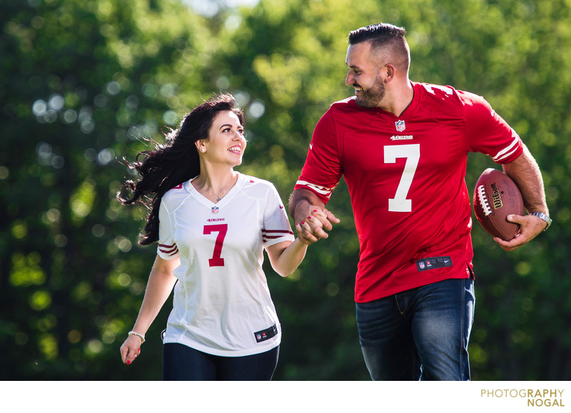 Football fan couple running with football