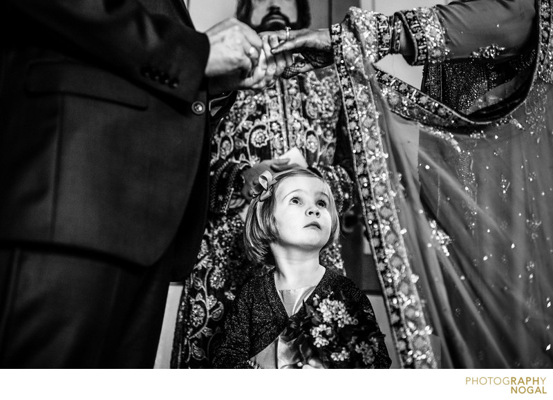 Flower Girl Looking at Bride and Groom's Ring Exchange 