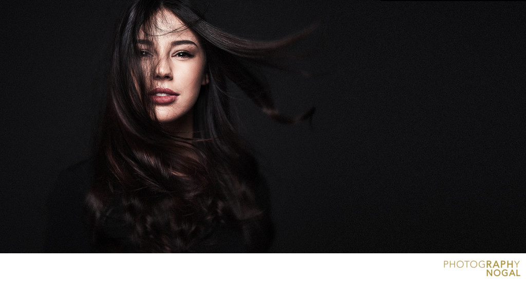 creative female headshot with hair flowing