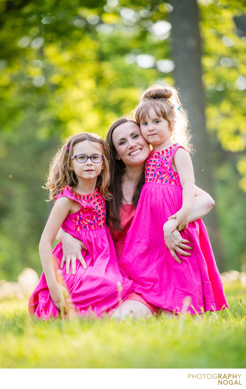 mom and two girls in pink dresses