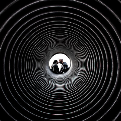 Couple kissing in the centre of a tunnel