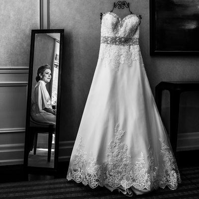 Bride in the Mirror Looking at Wedding Dress