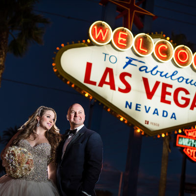 Bride and Groom in Front of Las Vegas Welcome Sign