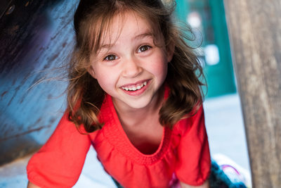 girl peeking through a tunnel and smiling