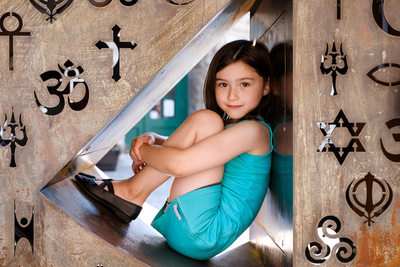 girl sitting in nook in art sculpture at the distillery