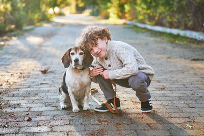 boy with beagle dog on a path in sam smith park